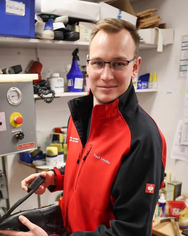 Paul Leyske in der Werkstatt mit einem Stiefel in der Hand